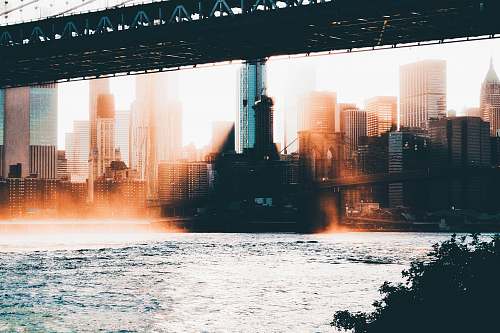 bridge photography of high-rise buildings near body of water dumbo